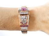 a woman ' s wrist that has a watch and a bracelet on it