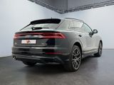 the rear end of a grey audi qx parked in a garage