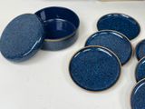 a lot of blue dishes sitting on a table