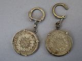 pair of silver coin earrings on a white surface
