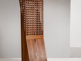une grande armoire en bois munie d'une porte et d'un panier posé dessus