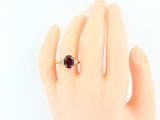 a woman ' s hand with a ring on it