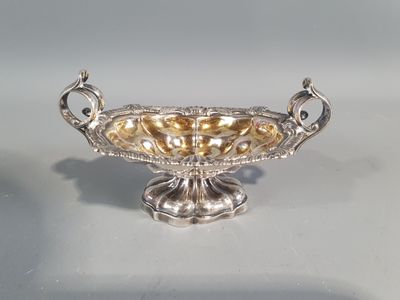 an image of a silver bowl on a table with a white background