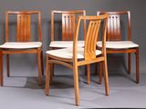 three wooden chairs sitting next to each other on a gray surface