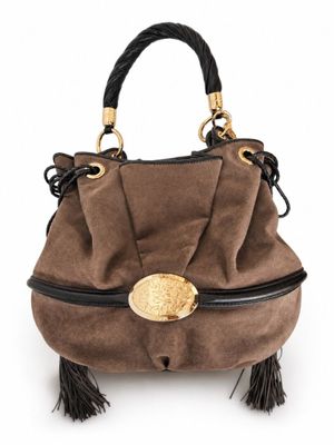 the small brown bag is sitting on a white surface