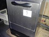 an image of a dishwasher sitting on top of a counter