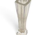 a clear glass vase with a silver base on a white background