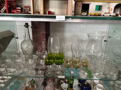 a glass display case filled with different types of glassware