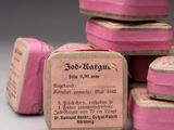 a stack of pink and white boxes with labels on them