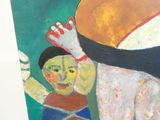 un tableau représentant une femme et un enfant posé sur une table