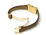 brown leather bracelet with a gold clasp on a white background