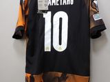 a close up of a jersey on a hanger on a wall