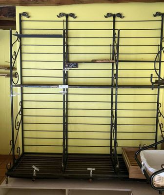 a shelf with a basket on top of it in a room