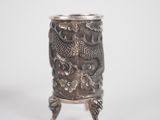 an image of a silver cup with a dragon design on it