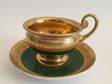 a cup and saucer sitting on a saucer on a plate