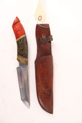 a knife and a sheath on a white surface