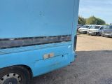 an image of a blue truck parked in a parking lot