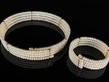 a close up of two bracelets and a ring on a black surface