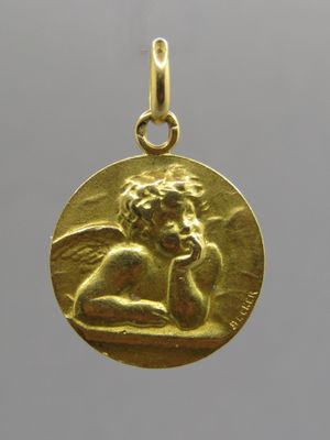a close up of a gold coin with an angel on it