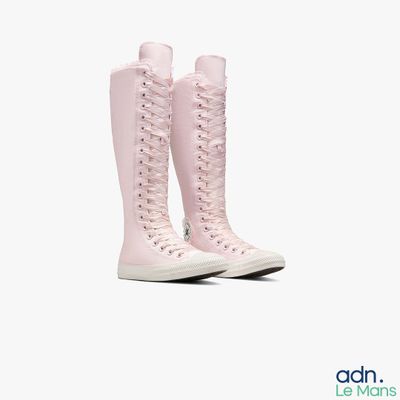 pink high - top sneakers with laces on a white background