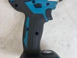 a close up of a cordless drill on a white surface
