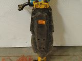 a yellow and black motorbike that is leaning against a wall