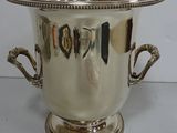 a silver vase with two handles on a table