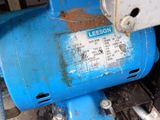a close up of a blue motor on the ground