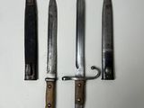 three knives are sitting on a white surface next to each other