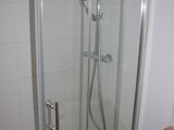 a shower with a glass door in a bathroom