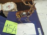 a blue box with a gold deer figurine on top of it