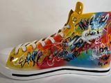 des baskets montantes aux couleurs vives, ornées de graffitis sur un fond blanc