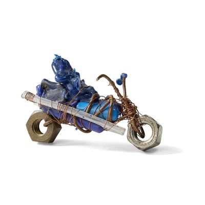 a figurine of a man riding a motorcycle with a basket on the back of it