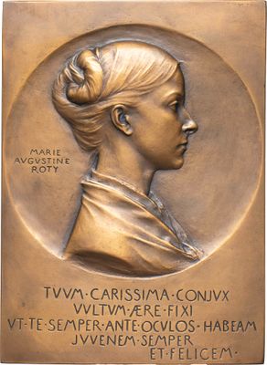 plaque en bronze représentant une femme avec une mèche de cheveux et une mèche de cheveux