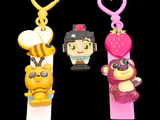 three key chains that are shaped like cartoon characters