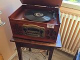 a record player sitting on top of a wooden table