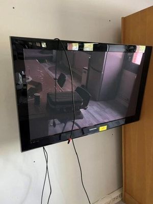 a flat screen tv hanging on the wall in the room