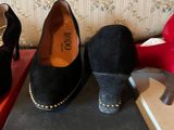 several pairs of women ' s shoes sitting on top of a box