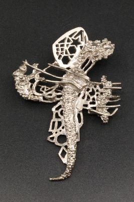 sterling silver dragon broochle on a black background