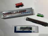 three toy trains sitting on a table next to each other