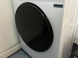 a white washer and a black dryer in a room