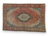 a red and blue rug with a medallion design on it