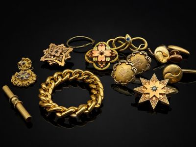 un gros plan sur un assortiment de bijoux posés sur une surface noire
