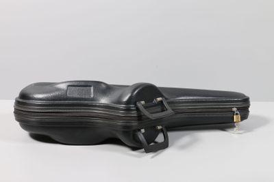 a black violin case sitting on a white table