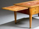 a wooden table with a drawer underneath it on a gray surface