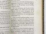 an open book on a white surface with a black border