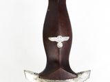 a close up of a sword with a bird on it