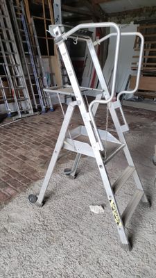 a ladder that is sitting on the floor in a room