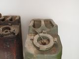 three old gas canisters sitting next to each other