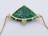 an image of a green and gold broochle on a gold chain